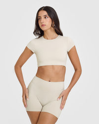 SoftMotion™ Short Sleeve Crop Top with White Logo | Sand