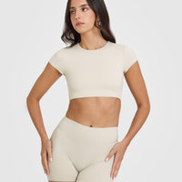 SoftMotion™ Short Sleeve Crop Top with White Logo | Sand