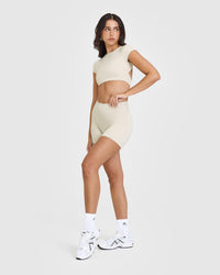 SoftMotion™ Short Sleeve Crop Top with White Logo | Sand