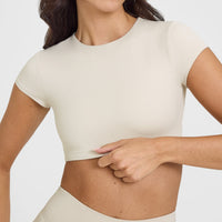 SoftMotion™ Short Sleeve Crop Top with White Logo | Sand