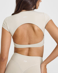 SoftMotion™ Short Sleeve Crop Top with White Logo | Sand