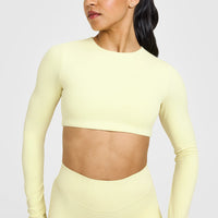SoftMotion™ Long Sleeve Crop Top with White Logo | Pastel Yellow