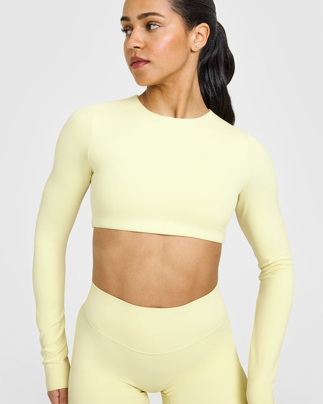SoftMotion™ Long Sleeve Crop Top with White Logo | Pastel Yellow