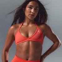EnhanceLift™ Seamless Minimal Halter Neck Bralette with White Logo | Charged Coral