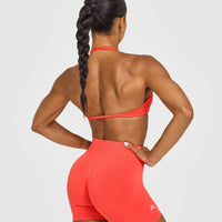 EnhanceLift™ Seamless Minimal Halter Neck Bralette with White Logo | Charged Coral