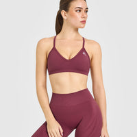EnhanceLift™ Seamless Strappy Sports Bra with White Logo | Burnt Maroon