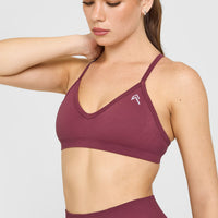 EnhanceLift™ Seamless Strappy Sports Bra with White Logo | Burnt Maroon