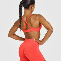 EnhanceLift™ Seamless Strappy Sports Bra with White Logo | Charged Coral