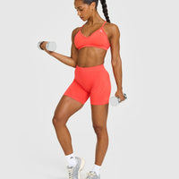 EnhanceLift™ Seamless Strappy Sports Bra with White Logo | Charged Coral