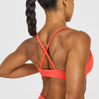 EnhanceLift™ Seamless Strappy Sports Bra with White Logo | Charged Coral