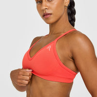 EnhanceLift™ Seamless Strappy Sports Bra with White Logo | Charged Coral