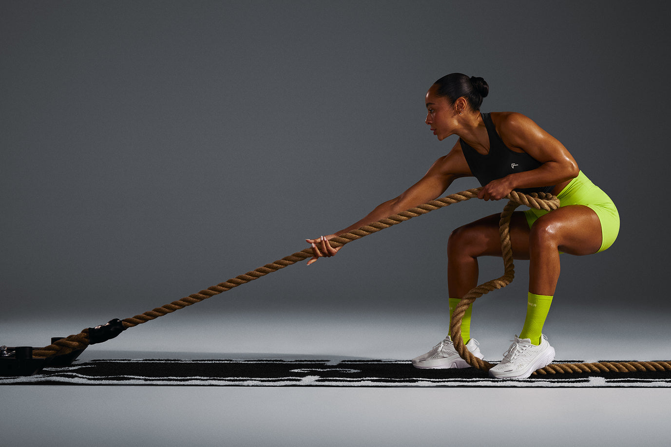Two models are shown from the legs up wearing matching long-sleeved tops and leggings in Vintage Purple and Dark Umber Brown. 