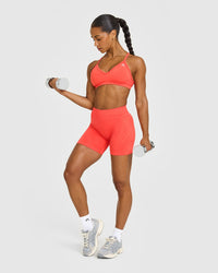 EnhanceLift™ Seamless Strappy Sports Bra with White Logo | Charged Coral