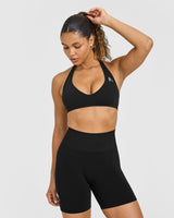 Effortless Seamless Halter Neck Sports Bra with White Logo | Black