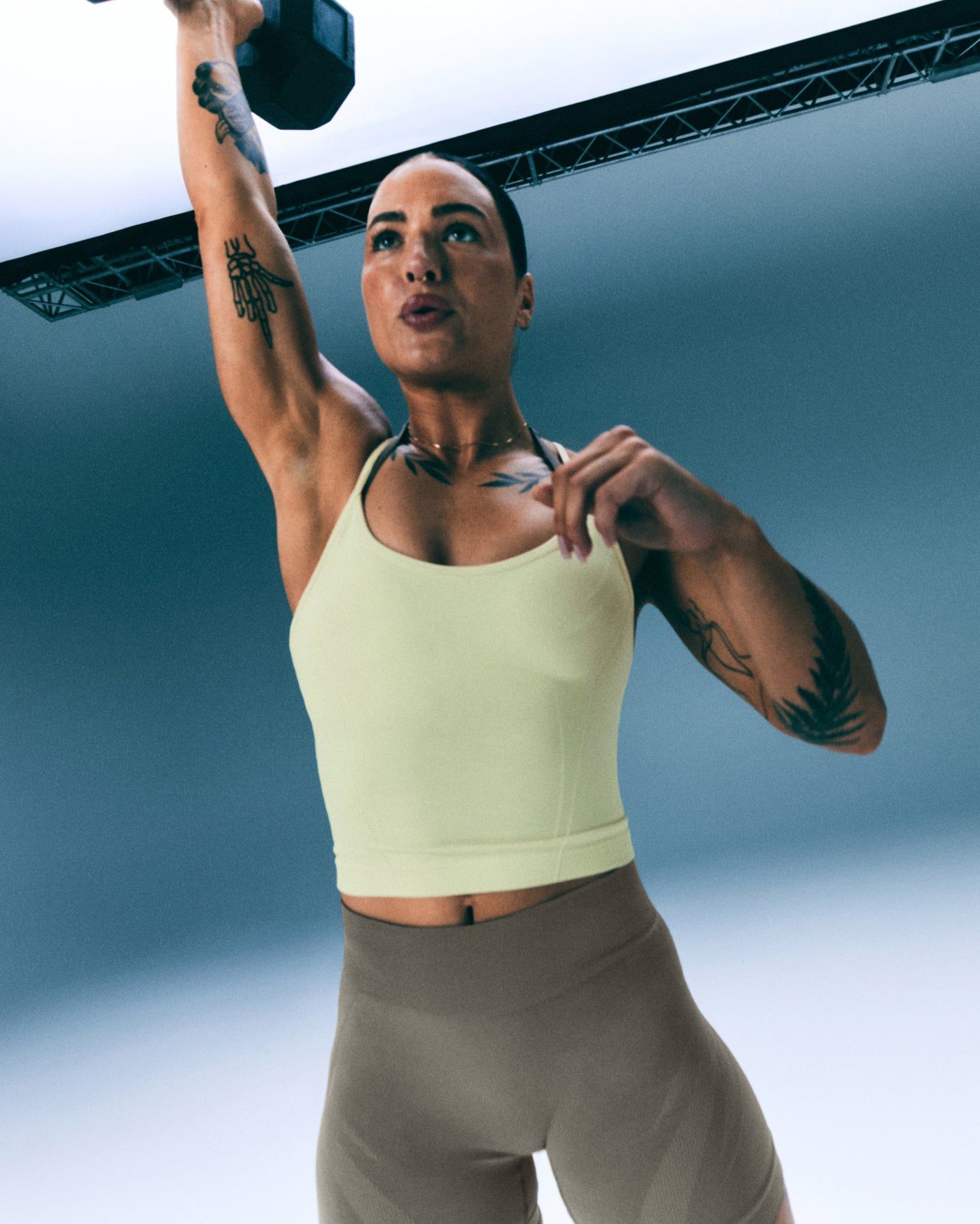 EnhanceLift™ Seamless Strappy Racer Tank Top with Built in Bra Shelf with Gray Logo | Pastel Yellow