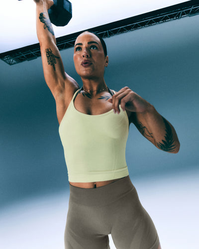 EnhanceLift™ Seamless Strappy Racer Tank Top with Built in Bra Shelf with Gray Logo | Pastel Yellow