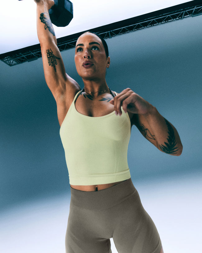 EnhanceLift™ Seamless Strappy Racer Tank Top with Built in Bra Shelf with Gray Logo | Pastel Yellow
