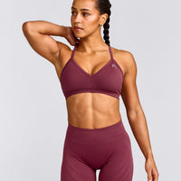 EnhanceLift™ Seamless Strappy Sports Bra with Gray Logo | Burnt Maroon