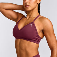 EnhanceLift™ Seamless Strappy Sports Bra with Gray Logo | Burnt Maroon