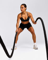 EnhanceLift™ Seamless Strappy Sports Bra with Gray Logo | Black