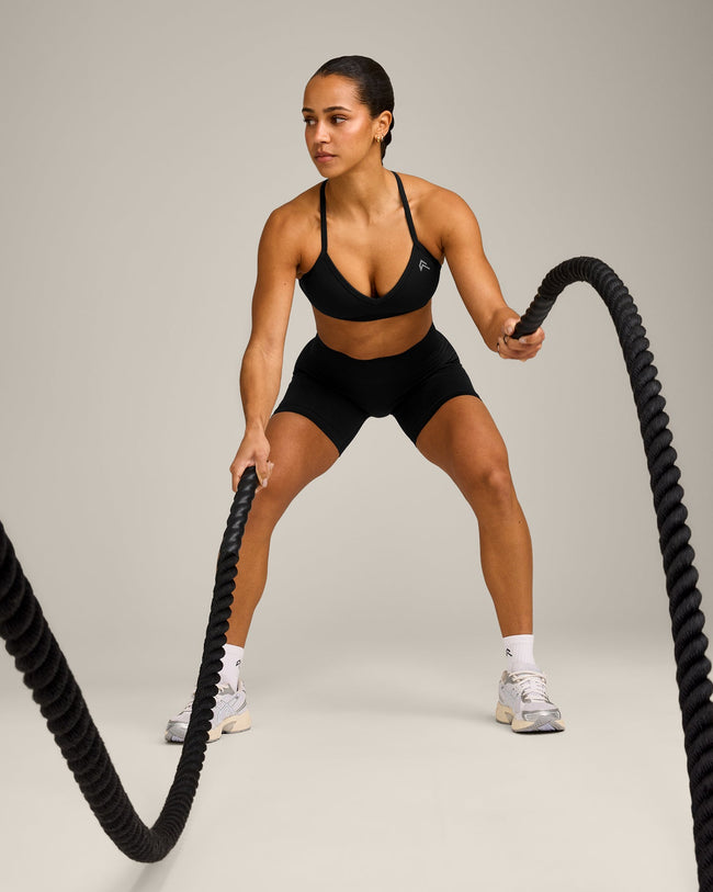 EnhanceLift™ Seamless Strappy Sports Bra with Gray Logo | Black