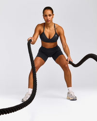 EnhanceLift™ Seamless Strappy Sports Bra with Gray Logo | Coal