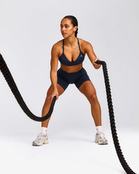 EnhanceLift™ Seamless Strappy Sports Bra with Gray Logo | True Blue