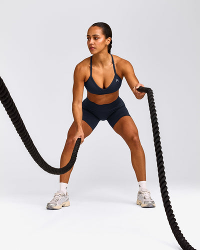 EnhanceLift™ Seamless Strappy Sports Bra with Gray Logo | True Blue