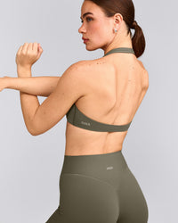 SoftMotion™ Minimal Halter Neck Bralette with Gray Logo | Alpine Green
