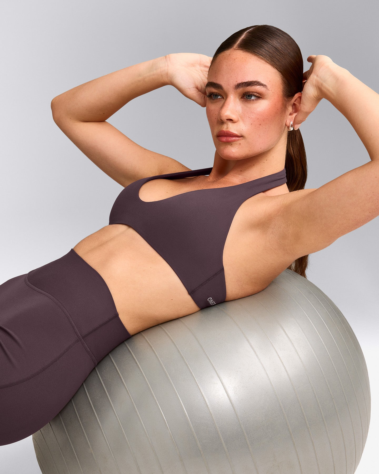 SoftMotion™ Minimal Halter Neck Bralette with Gray Logo | Dark Umber Brown