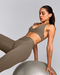SoftMotion™ Minimal Halter Neck Bralette with Gray Logo | Moss Brown