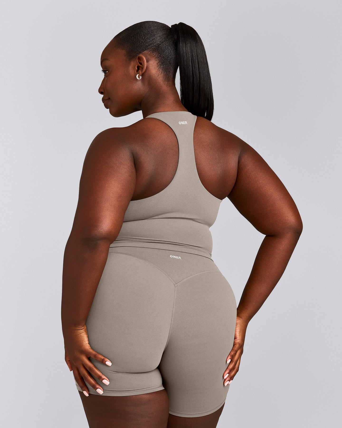 SoftMotion™ Racer Back Mid Tank Top with Built in Bra Shelf with White Logo | Warm Sand