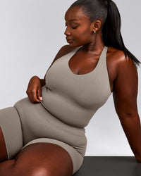 SoftMotion™ Racer Back Mid Tank Top with Built in Bra Shelf with White Logo | Warm Sand