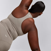 SoftMotion™ Racer Back Mid Tank Top with Built in Bra Shelf with White Logo | Warm Sand