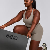 SoftMotion™ Racer Back Mid Tank Top with Built in Bra Shelf with White Logo | Warm Sand