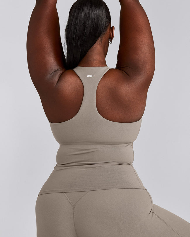 SoftMotion™ Racer Back Tank Top with Built in Bra Shelf with White Logo | Warm Sand