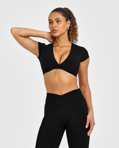 UnifiedMove Twist Front Short Sleeve Crop Top White Logo in Black