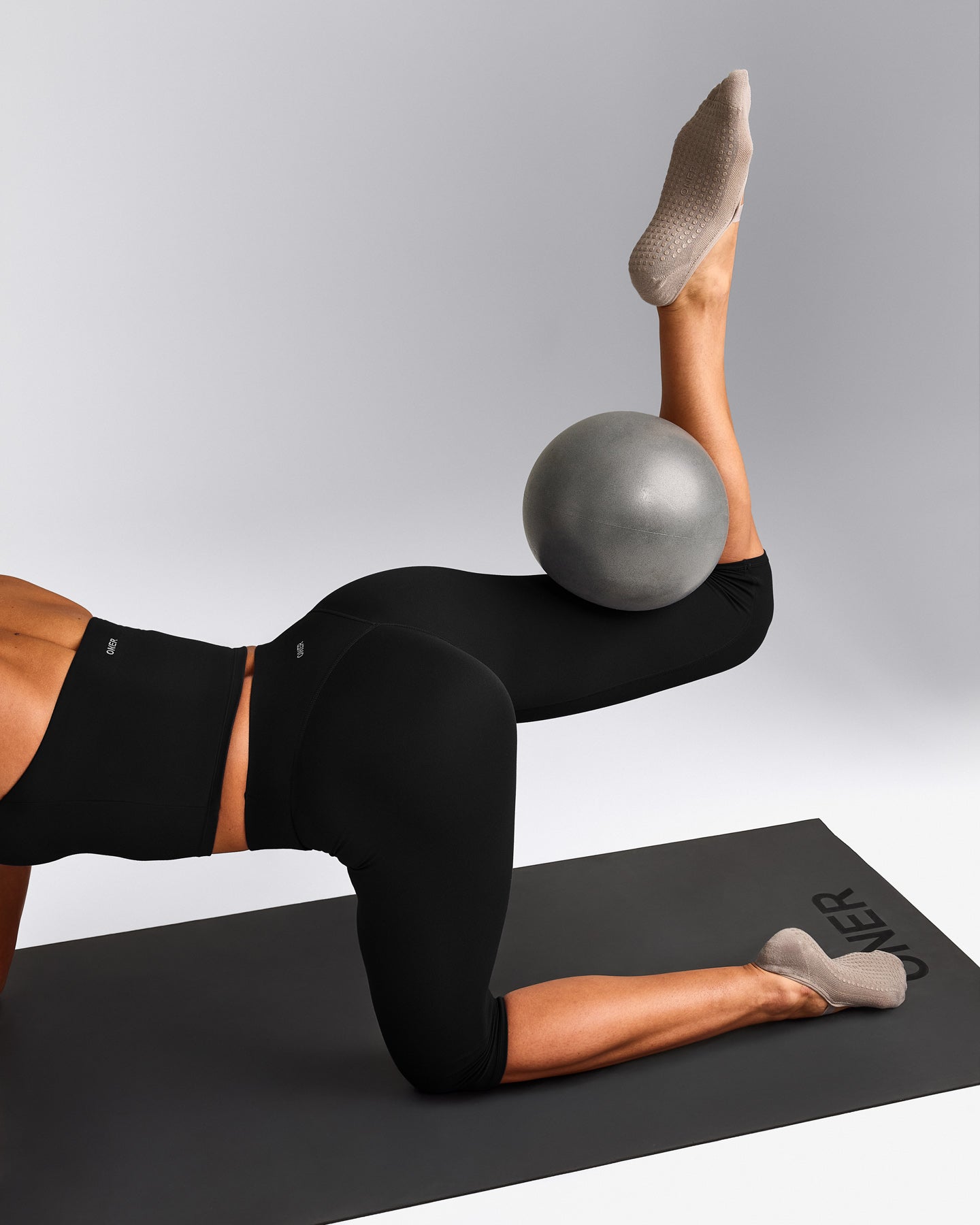 SoftMotion™ High Waisted Capri Leggings with Gray Logo | Black