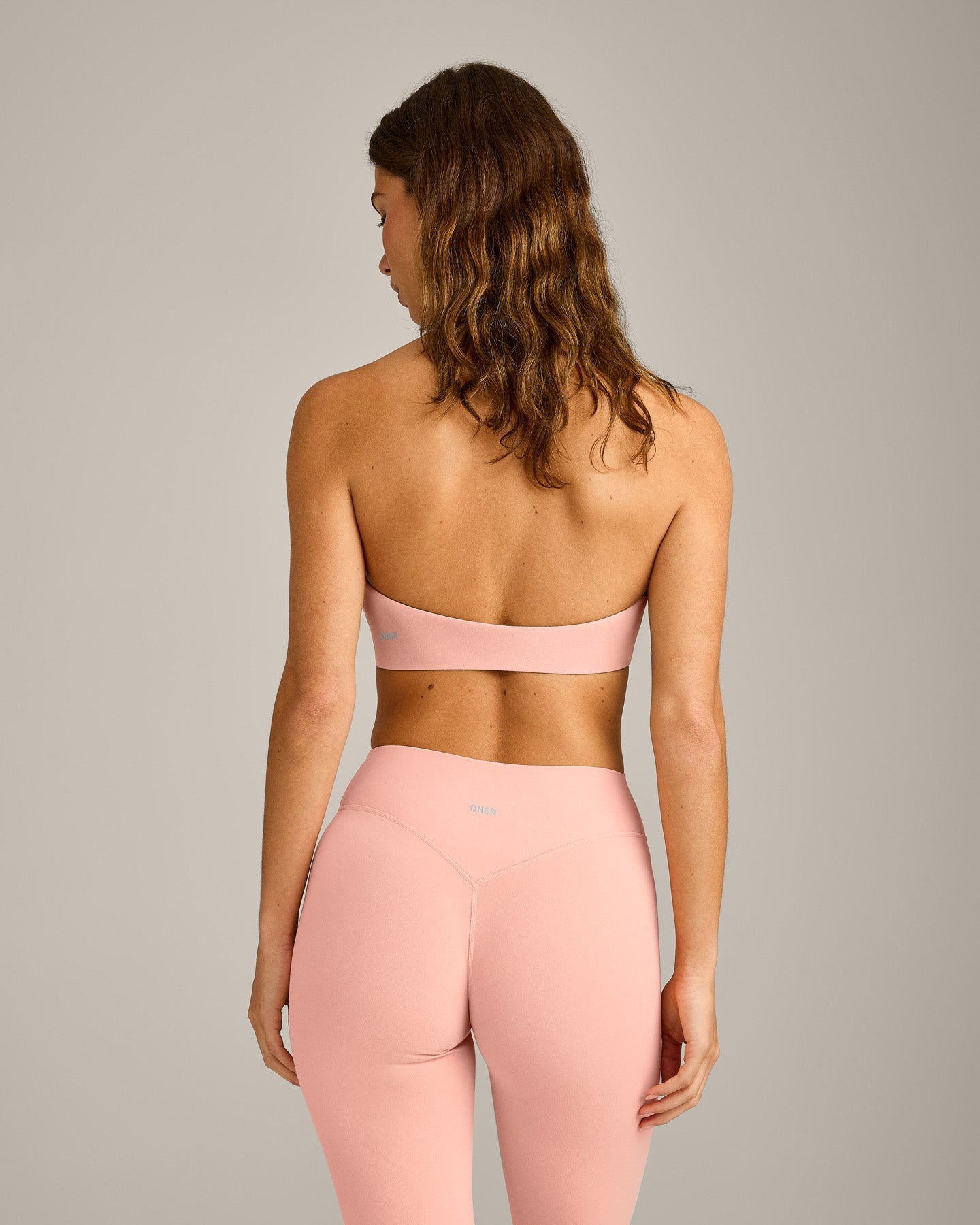 SoftMotion™ Minimal Halter Neck Bralette with Gray Logo | Peach Orange