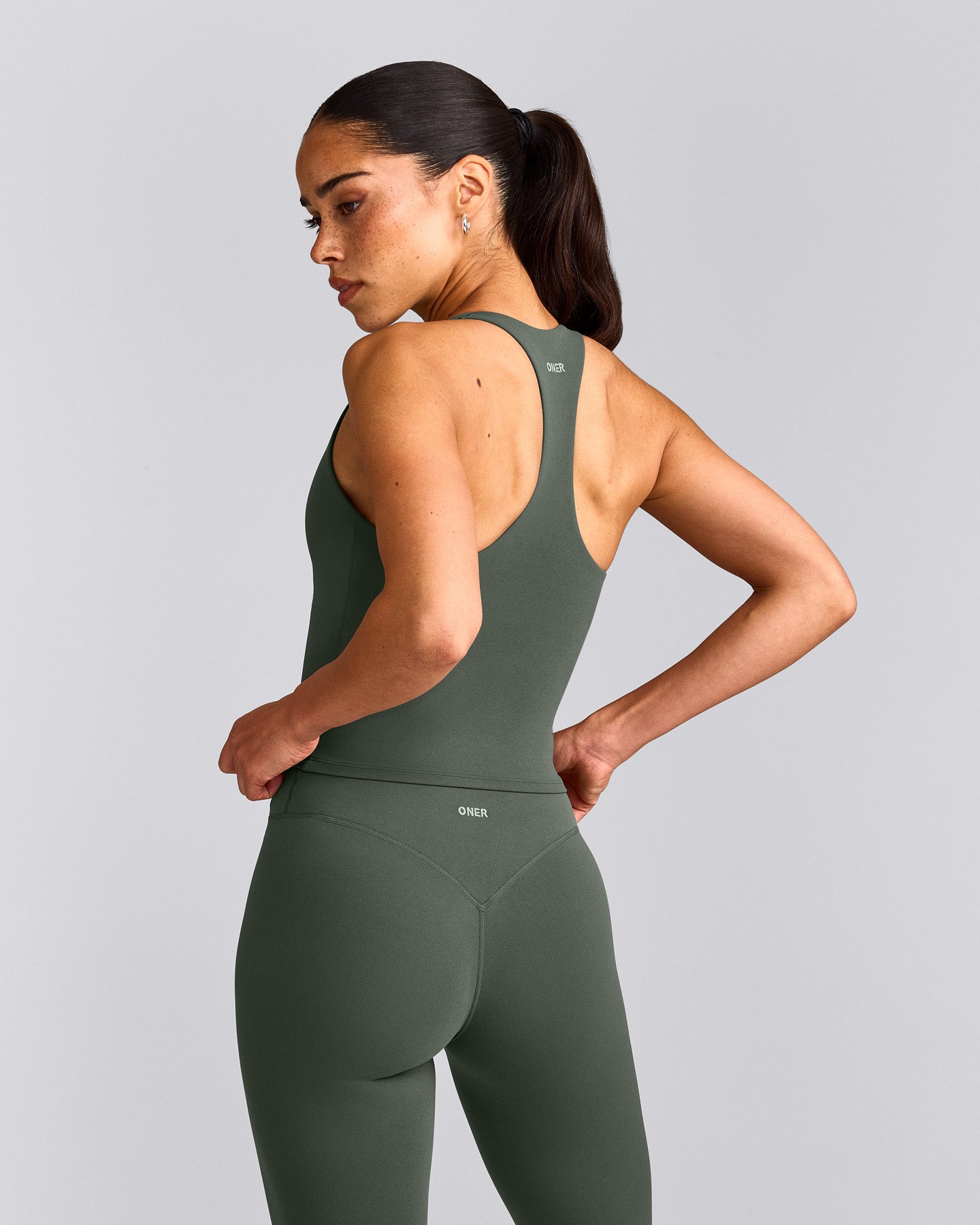 SoftMotion™ Racer Back Mid Tank Top with Built in Bra Shelf with Gray Logo | Dark Khaki