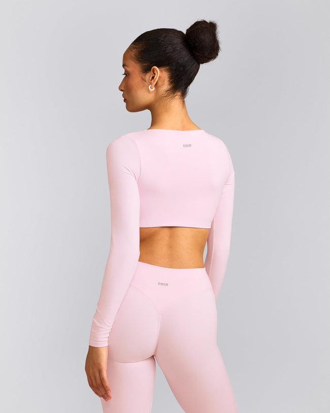 SoftMotion™ Scoop Neck Long Sleeve Crop Top with Built in Bra Shelf with Gray Logo | Soft Girl Pink