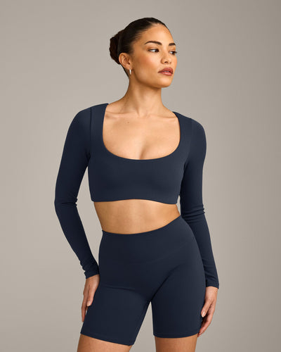 SoftMotion™ Scoop Neck Long Sleeve Crop Top with Built in Bra Shelf with Gray Logo | True Blue