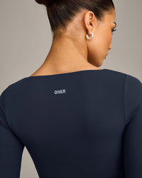 SoftMotion™ Scoop Neck Long Sleeve Crop Top with Built in Bra Shelf with Gray Logo | True Blue