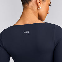 SoftMotion™ Scoop Neck Long Sleeve Crop Top with Built in Bra Shelf with Gray Logo | True Blue