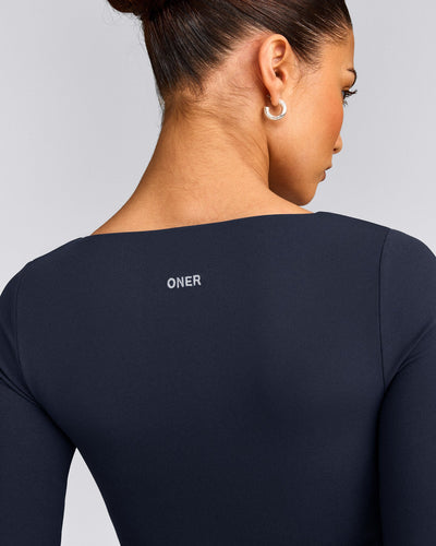 SoftMotion™ Scoop Neck Long Sleeve Crop Top with Built in Bra Shelf with Gray Logo | True Blue