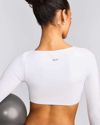 SoftMotion™ Scoop Neck Long Sleeve Crop Top with Built in Bra Shelf with Gray Logo | White