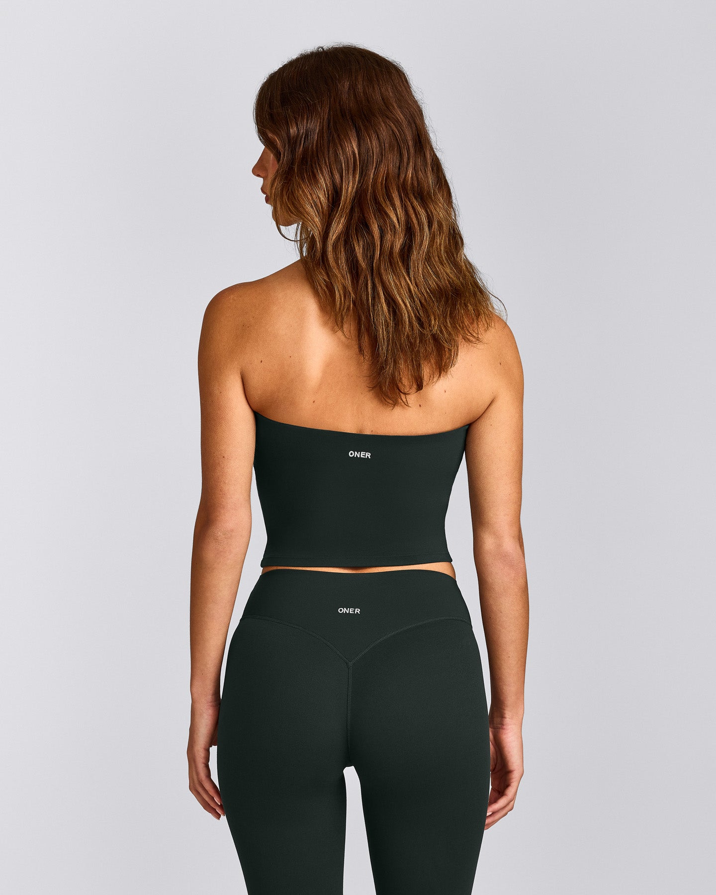 SoftMotion™ Bandeau Mid Tank Top with Built in Bra Shelf with Gray Logo | Emerald Noir