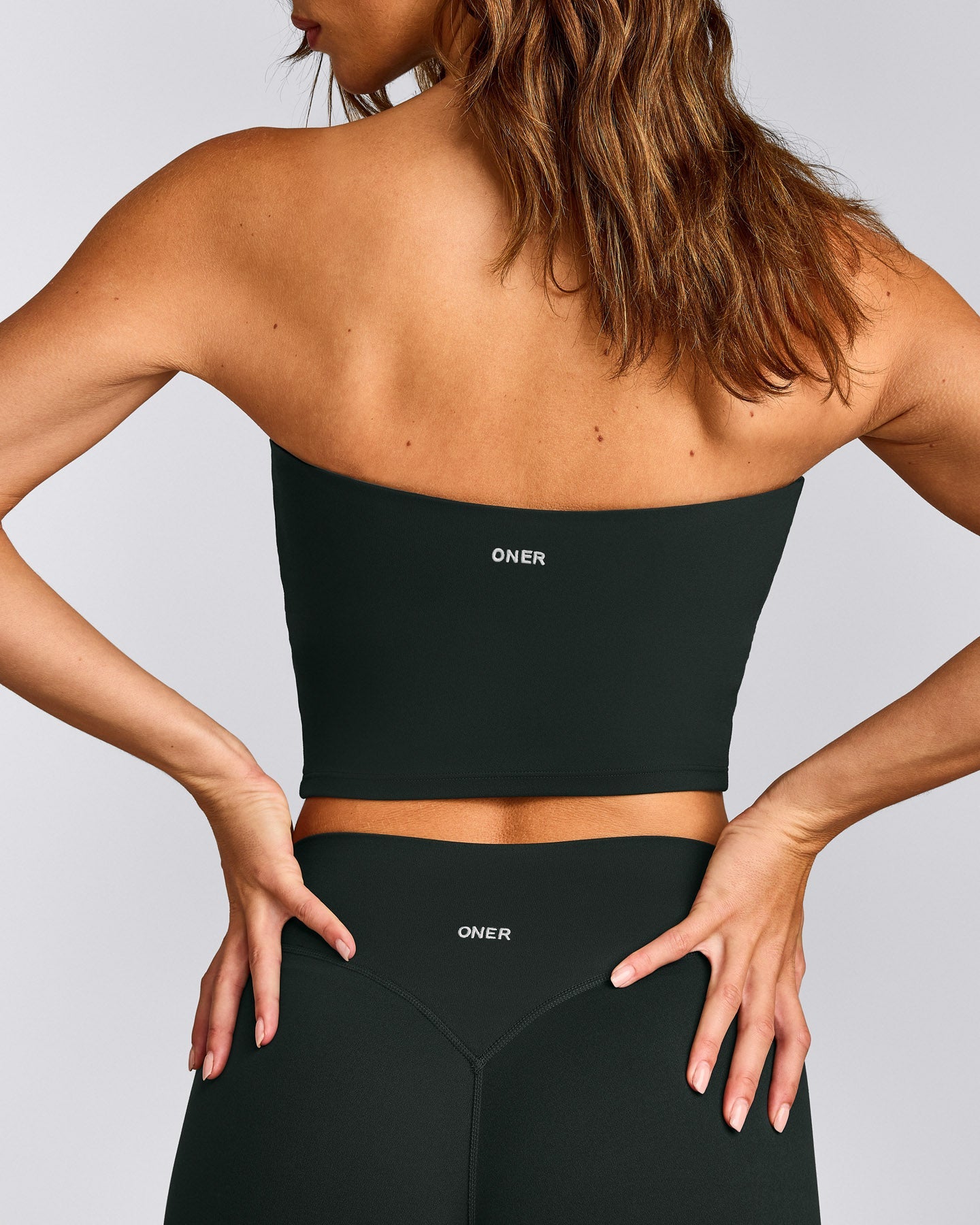 SoftMotion™ Bandeau Mid Tank Top with Built in Bra Shelf with Gray Logo | Emerald Noir