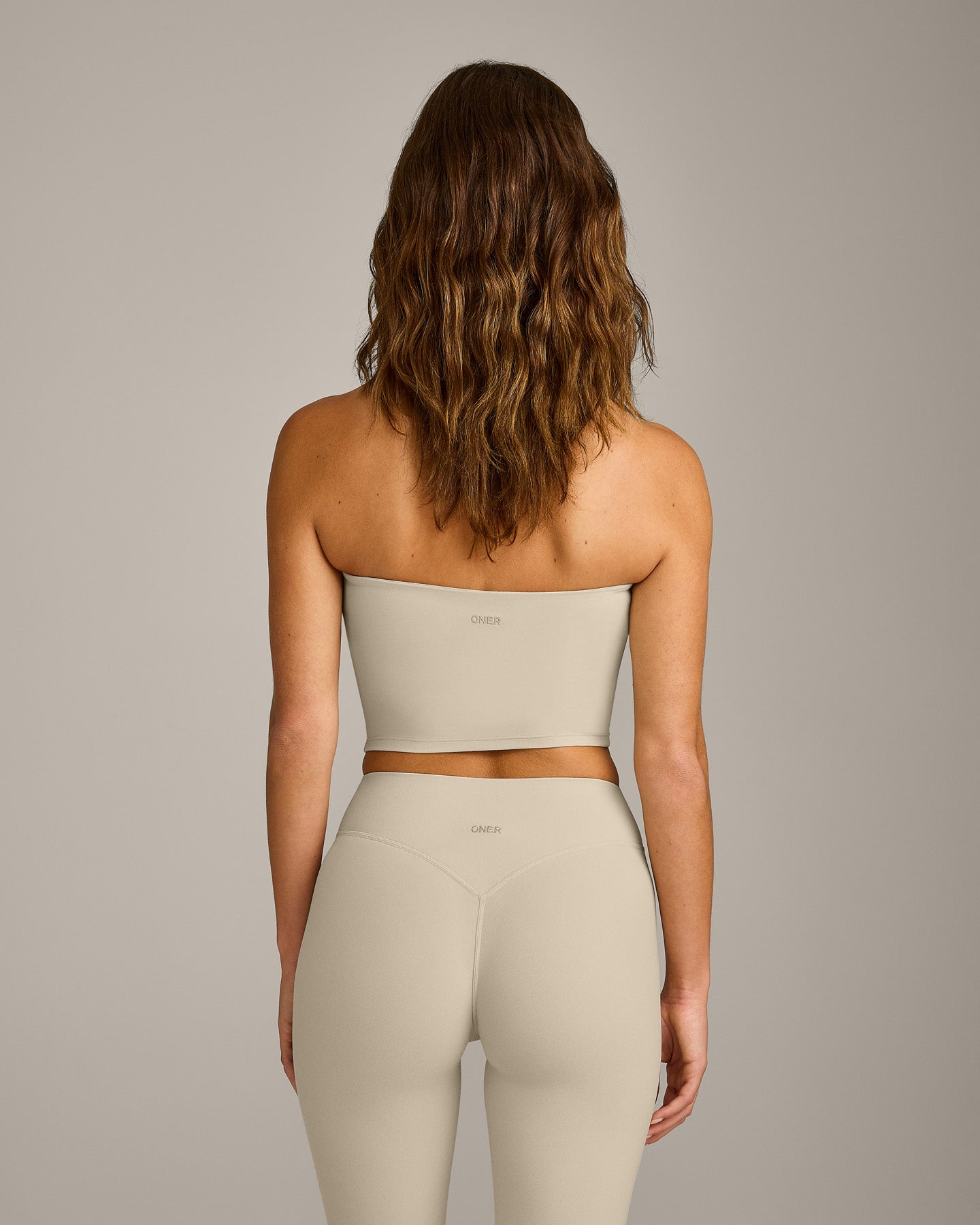 SoftMotion™ Bandeau Mid Tank Top with Built in Bra Shelf with Gray Logo | Oatmeal