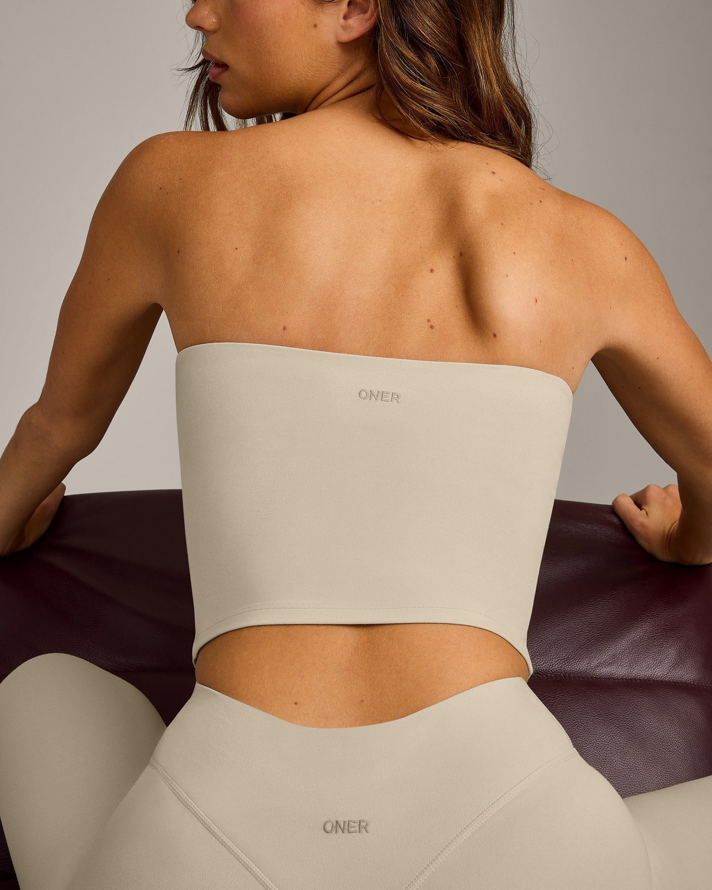 SoftMotion™ Bandeau Mid Tank Top with Built in Bra Shelf with Gray Logo | Oatmeal